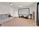 Living room features a large projector screen, gray sofa, and white refrigerator at 282 Fischer Rd, Fort Mill, SC 29175