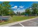 Community playground features climbing structures, slides, swings, and green grass, with ample parking nearby at 282 Fischer Rd, Fort Mill, SC 29175
