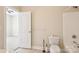 Small bathroom with tile floor, toilet, towel bar, shower-tub combination, and view to a carpeted room at 2910 Lake James Ct, Monroe, NC 28110