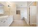 Bathroom featuring a double vanity, neutral tile floor, and access to a soaking tub at 2910 Lake James Ct, Monroe, NC 28110