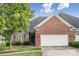Charming home featuring a brick and stone facade, an attached two-car garage, and a well-manicured lawn at 2910 Lake James Ct, Monroe, NC 28110