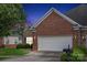 This home features a two-car garage and a combination of brick and stone, offering both functionality and curb appeal at 2910 Lake James Ct, Monroe, NC 28110