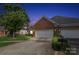 This home features a two-car garage and a combination of brick and stone, offering both functionality and curb appeal at 2910 Lake James Ct, Monroe, NC 28110
