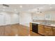 Open floor plan shows kitchen with wooden cabinets and a view into the carpeted living area at 2910 Lake James Ct, Monroe, NC 28110