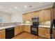 Bright kitchen featuring wooden cabinets, modern appliances, and beautiful tile backsplash at 2910 Lake James Ct, Monroe, NC 28110