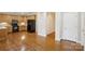 View from the hardwood floor to the bright kitchen with stainless steel appliances and cabinets at 2910 Lake James Ct, Monroe, NC 28110