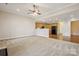 Open-concept living room with carpet flooring and view into the modern kitchen at 2910 Lake James Ct, Monroe, NC 28110