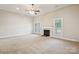 Light-filled living room featuring a fireplace, high ceilings, and neutral walls at 2910 Lake James Ct, Monroe, NC 28110