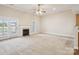 Spacious living room with a fireplace, neutral carpet and access to a patio at 2910 Lake James Ct, Monroe, NC 28110