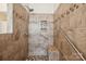 Tile shower featuring a built-in bench and convenient grab bars for accessibility at 2910 Lake James Ct, Monroe, NC 28110