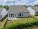 Aerial view of the fenced backyard with a concrete patio, green grass, and well-maintained greenery at 3043 Santee Ct, Fort Mill, SC 29707