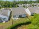 A high-angle view displays a tidy backyard with fencing, trees and green grass at 3043 Santee Ct, Fort Mill, SC 29707