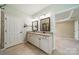 Bathroom featuring double vanities with granite countertops and a doorway leading to another room at 3043 Santee Ct, Fort Mill, SC 29707