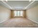 Bedroom featuring carpet floors, tray ceilings, and lots of natural light at 3043 Santee Ct, Fort Mill, SC 29707