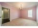 Bedroom with pink walls, carpet, a chandelier, and a window at 3043 Santee Ct, Fort Mill, SC 29707