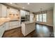 Bright eat-in kitchen featuring white cabinets, stainless steel appliances, and a granite island at 3043 Santee Ct, Fort Mill, SC 29707