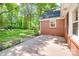 Backyard area with brick house, wooden patio, some landscape lighting, and large grassy space at 308 Gillsbrook Rd, Lancaster, SC 29720