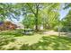 Expansive backyard with mature trees, seating area, fire pit, and detached garage at 308 Gillsbrook Rd, Lancaster, SC 29720