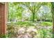Spacious backyard with mature trees, a fire pit area, detached garage and lush lawn at 308 Gillsbrook Rd, Lancaster, SC 29720