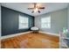 Bright bedroom featuring hardwood floors, a modern chair, and ample natural light at 308 Gillsbrook Rd, Lancaster, SC 29720