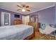 Comfortable bedroom with a traditional bed, wood floors, and a chair at 308 Gillsbrook Rd, Lancaster, SC 29720