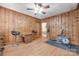 Spacious bonus room featuring knotty pine walls, wood floors, and exercise equipment at 308 Gillsbrook Rd, Lancaster, SC 29720