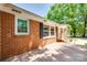 Charming brick home featuring a cozy porch, white pillars, and well-maintained landscaping at 308 Gillsbrook Rd, Lancaster, SC 29720