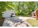 View of a charming house and detached garage in lush green backyard with sunny sky at 308 Gillsbrook Rd, Lancaster, SC 29720