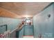 Long hallway with wooden ceiling and light blue walls with a staircase on the left side of the shot at 308 Gillsbrook Rd, Lancaster, SC 29720
