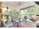 Relaxing screened-in porch with comfortable seating, hanging swing chair, and beautiful views of the outdoors at 308 Gillsbrook Rd, Lancaster, SC 29720