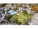 Aerial view of pool and clubhouse surrounded by green lawns and fall foliage at 3109 Heathstead Pl, Charlotte, NC 28210