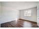 Bedroom with wood floors and natural light from the window at 3109 Heathstead Pl, Charlotte, NC 28210