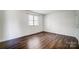 Bedroom with wood floors, natural light from the window, and closet at 3109 Heathstead Pl, Charlotte, NC 28210