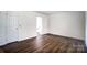 Bright bedroom featuring neutral walls and dark hardwood floors at 3109 Heathstead Pl, Charlotte, NC 28210