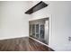 Modern fireplace featuring a metal frame, hardwood flooring, and white walls at 3109 Heathstead Pl, Charlotte, NC 28210
