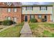 Inviting townhome featuring brick facade, black shutters, and a well-manicured front yard at 3109 Heathstead Pl, Charlotte, NC 28210