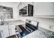 Updated kitchen featuring stainless steel appliances, granite countertops, and sleek black stovetop at 3109 Heathstead Pl, Charlotte, NC 28210