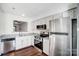 Kitchen featuring stainless steel appliances and granite countertops that opens up to the living room at 3109 Heathstead Pl, Charlotte, NC 28210
