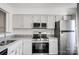 Updated kitchen with stainless steel appliances, granite countertops, and white cabinets at 3109 Heathstead Pl, Charlotte, NC 28210