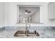 View of kitchen sink and granite countertops looking into the living room at 3109 Heathstead Pl, Charlotte, NC 28210