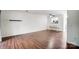 Bright living room featuring wood floors, modern ceiling fan, and pass-through window to the kitchen at 3109 Heathstead Pl, Charlotte, NC 28210