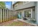 Outdoor patio area with wood fencing, a door, a fire pit, and a light-blue chair at 3109 Heathstead Pl, Charlotte, NC 28210