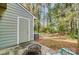 Outdoor patio with AC, door, light-green siding, and a fire pit surrounded by grass and trees at 3109 Heathstead Pl, Charlotte, NC 28210