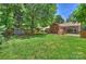 Expansive lawn in the backyard with storage shed, swing set, and partial fence at 3901 Kitley Pl, Charlotte, NC 28210
