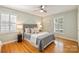 Bright bedroom with a ceiling fan, plantation shutters, and warm hardwood floors at 3901 Kitley Pl, Charlotte, NC 28210
