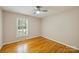 Cozy bedroom features plantation shutters, hardwood floors, and plenty of natural light at 3901 Kitley Pl, Charlotte, NC 28210