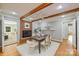 Dining room has wood floors, brick fireplace, decorative wood beams, and an open floorplan at 3901 Kitley Pl, Charlotte, NC 28210