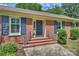 Close-up of the brick home's entrance with blue shutters and a matching blue front door at 3901 Kitley Pl, Charlotte, NC 28210