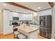 Bright kitchen features stainless appliances, white cabinets, granite counters, and a butcher block island at 3901 Kitley Pl, Charlotte, NC 28210