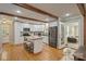 Bright eat-in kitchen boasts stainless appliances, white cabinetry, butcher block island and wood beams at 3901 Kitley Pl, Charlotte, NC 28210